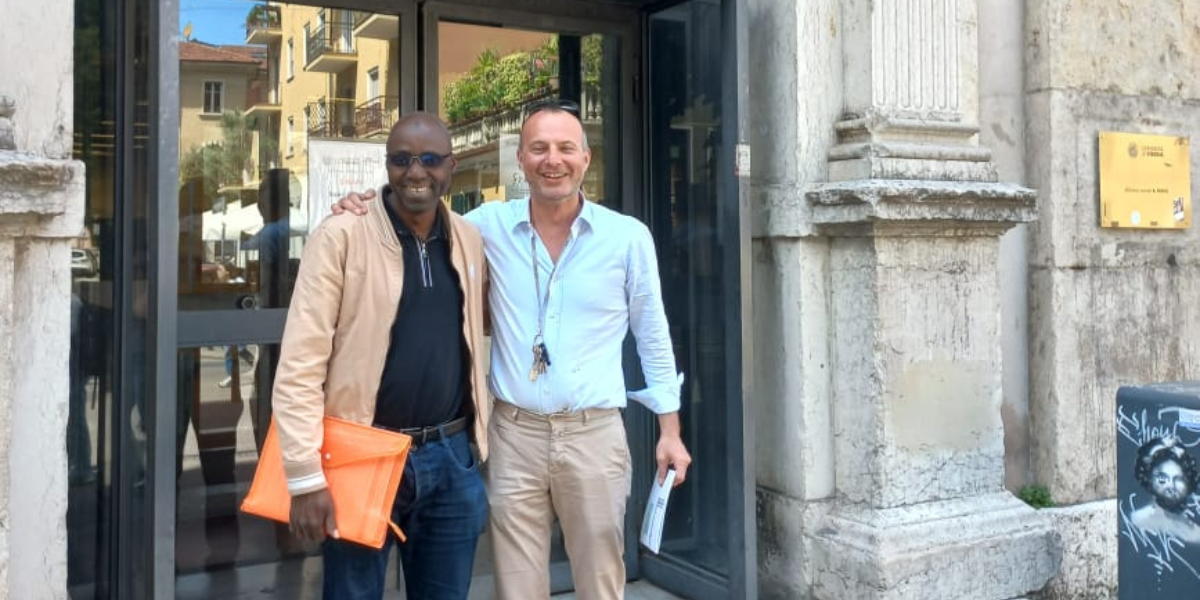 Massimo Salgaro and Lacina Yéo outside the entrance of the Frinzi library